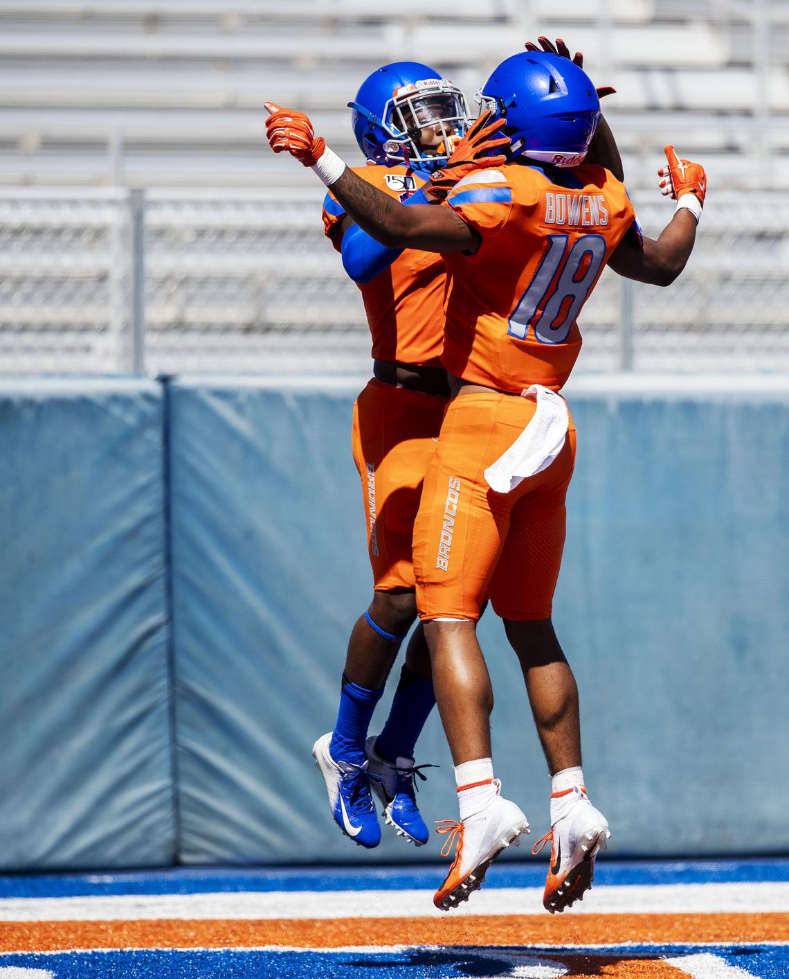 Boise State wide receiver CT Thomas celebrates a touchdown with teammate Billy Bowens during the Fall Fan Fest practice Aug. 24 at Albertsons Stadium in Boise.