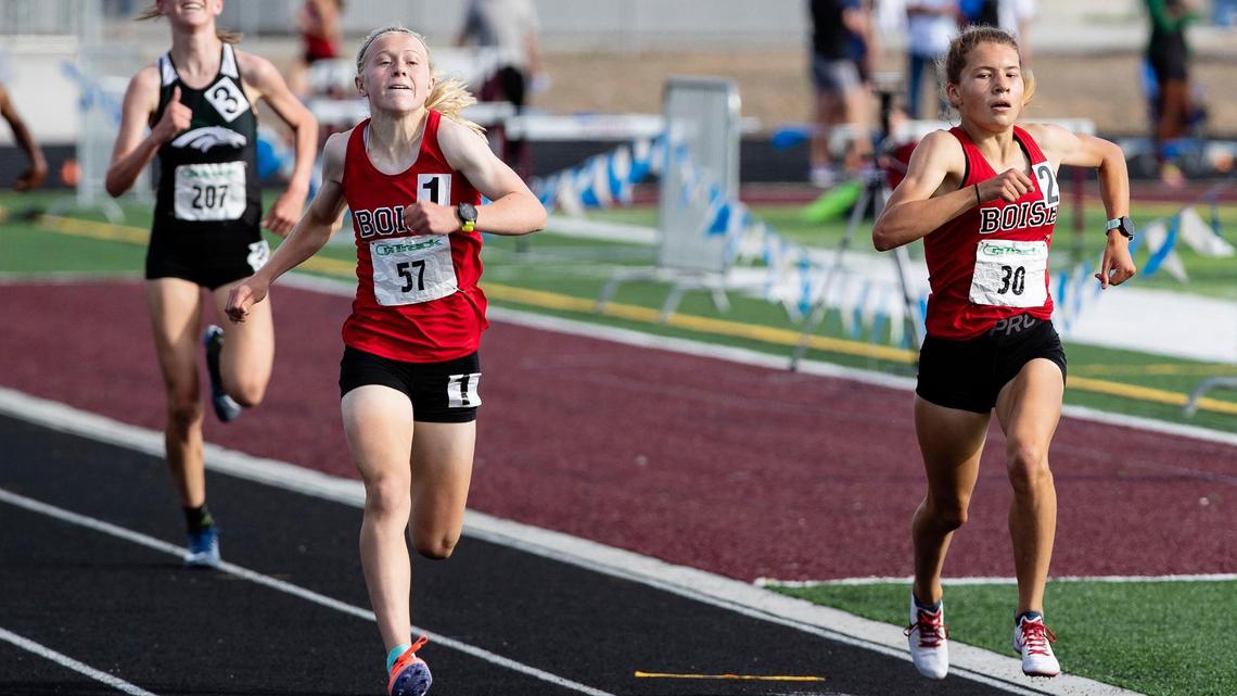 Boise High teammates Sammy Smith, left, and Allie Bruce, right, are neck and neck in the 1,600 meters during the 5A District Three track and field championships Friday at Centennial High. Smith took first place by .04 seconds.