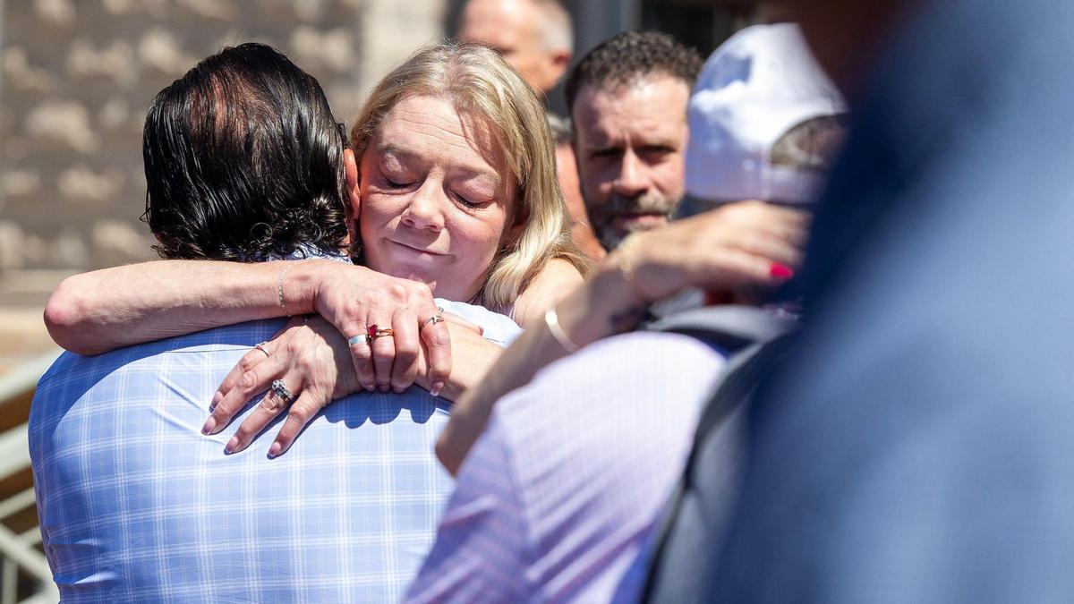 Karen Laramie, right, mother of Madison Mogen, hugs Steve Goncalves, father of Kaylee Goncalves, outside of the Ada County Courthouse after the sentencing of Bryan Kohberger. 