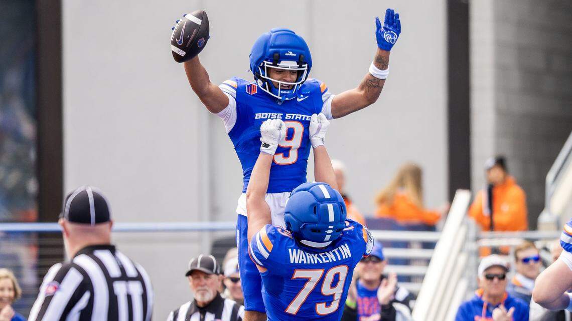 Boise State wide receiver Rasean Jones gets hoisted into the air by offensive lineman Connor Warkentin after catching a touchdown pass in the Broncos' annual spring game for fans at Albertsons Stadium in Boise on Saturday, April 25, 2026.