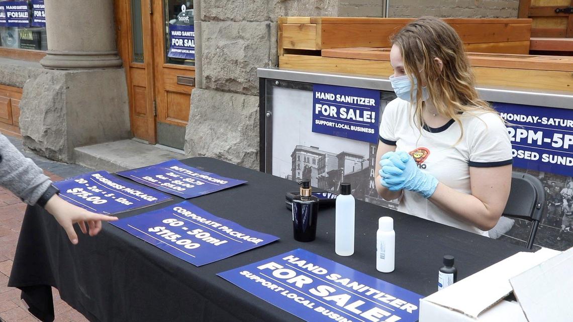Isabela Green, normally a cocktail waitress at Amsterdam Lounge in Downtown Boise, sells regionally made hand sanitizer instead in front of the lounge while it’s closed. Bars will be among the last businesses to reopen under Gov. Brad Little’s proposed plan.