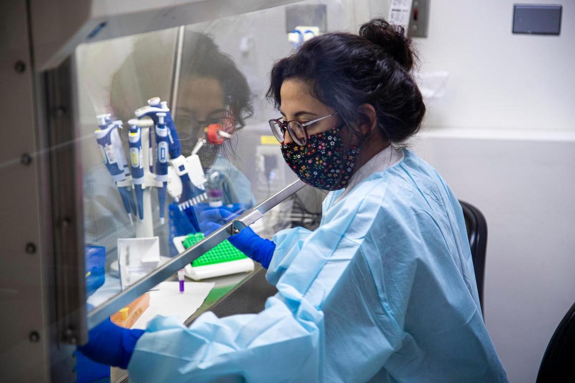 Aimee Ceniseros, a senior microbiologist at the Idaho Bureau of Laboratories in Boise, prepares COVID-19 samples collected by healthcare workers for RNA extraction.