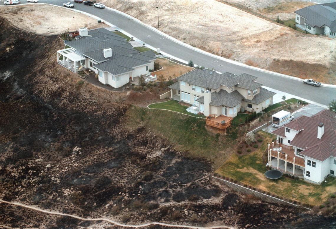 Blackened earth shows how close the 1996 8th Street Fire came to homes on Nines Ridge. Photo taken Aug. 27, 1996