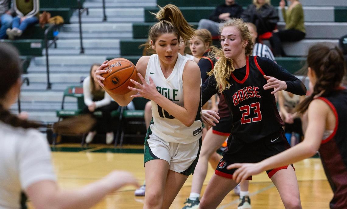 Eagle’s Paige Cofer, left, maneuvers the ball around Boise’s Avery Howell last season.