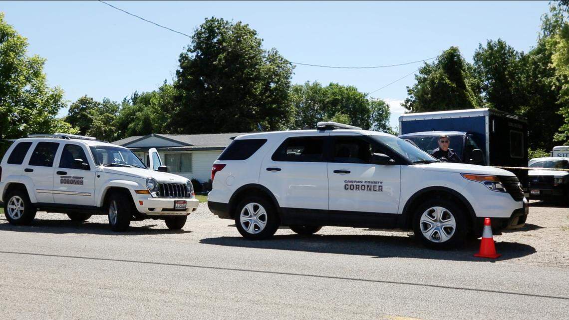 In this Statesman file photo, Canyon County Coroner’s Office vehicles sit ioutside a home on KCID Road where three bodies were found in June of 2017,