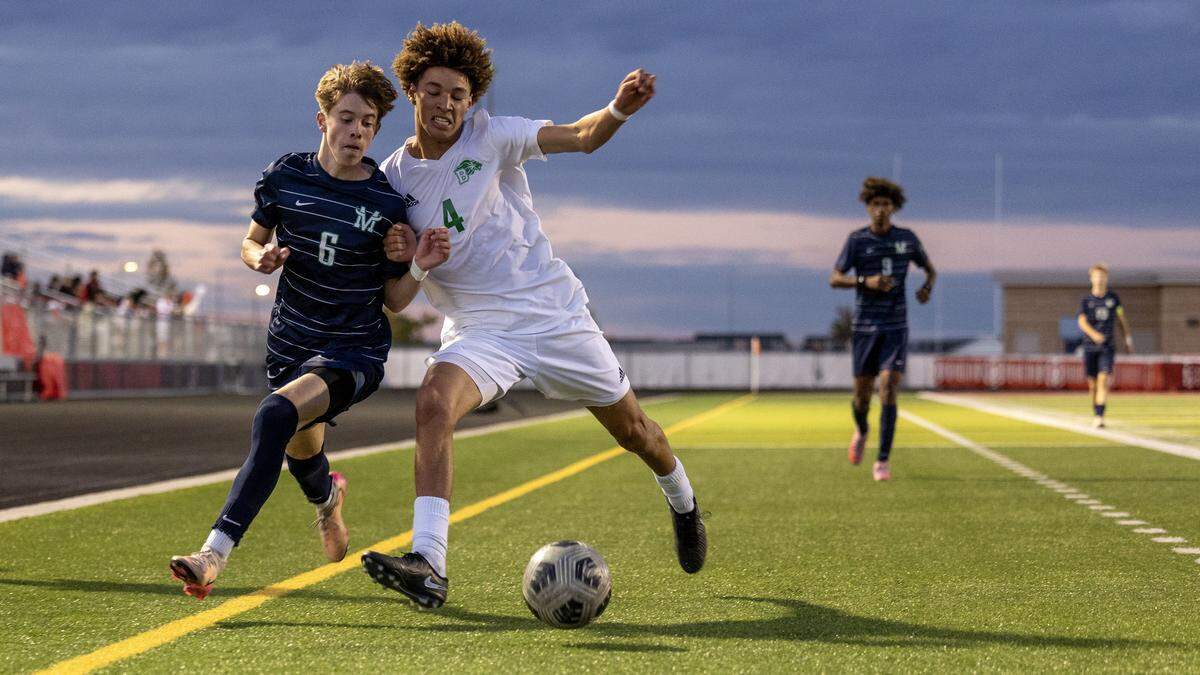 Mountain View sophomore Jayden Duppong and Borah's Isaac Alford fight for control of the ball along the sideline in the 6A District Three boys soccer tournament semifinals at Owyhee High School in Meridian, Monday, Oct. 13, 2025.