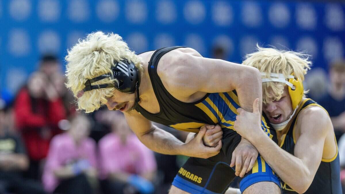 Caldwell's Jaxson Freeman, left, and Meridian's Justus Briggs, right, compete in the 6A 126-lbs. division first place match at the Idaho state wrestling championships held at the Ford Idaho Center in Nampa, Saturday, Feb. 28, 2026. Freeman won.