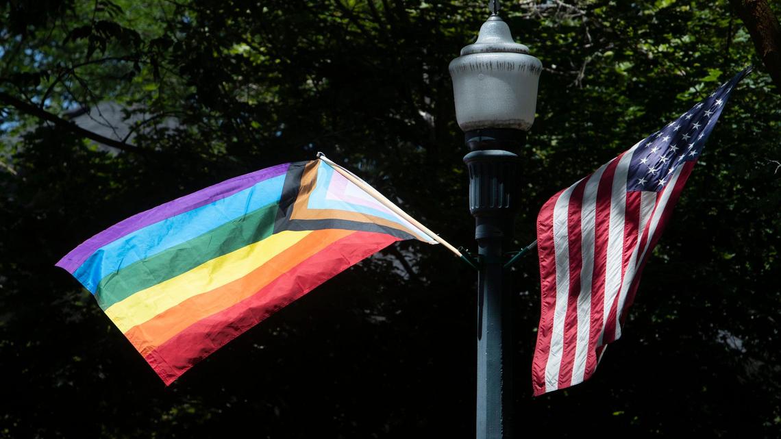 A Progressive Pride flag flies next to an American flag on from a streetlamp on Harrison Blvd. at Ada Street in Boise in this 2021 file photo.