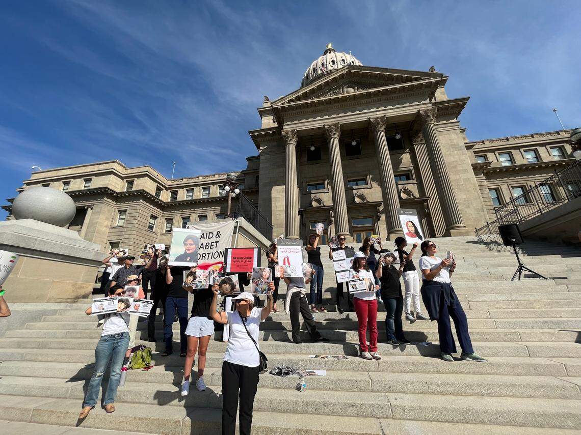 Members of Boise’s Iranian community hold posters at Saturday’s rally. Organizers of the Women’s March event invited them to participate in solidarity.