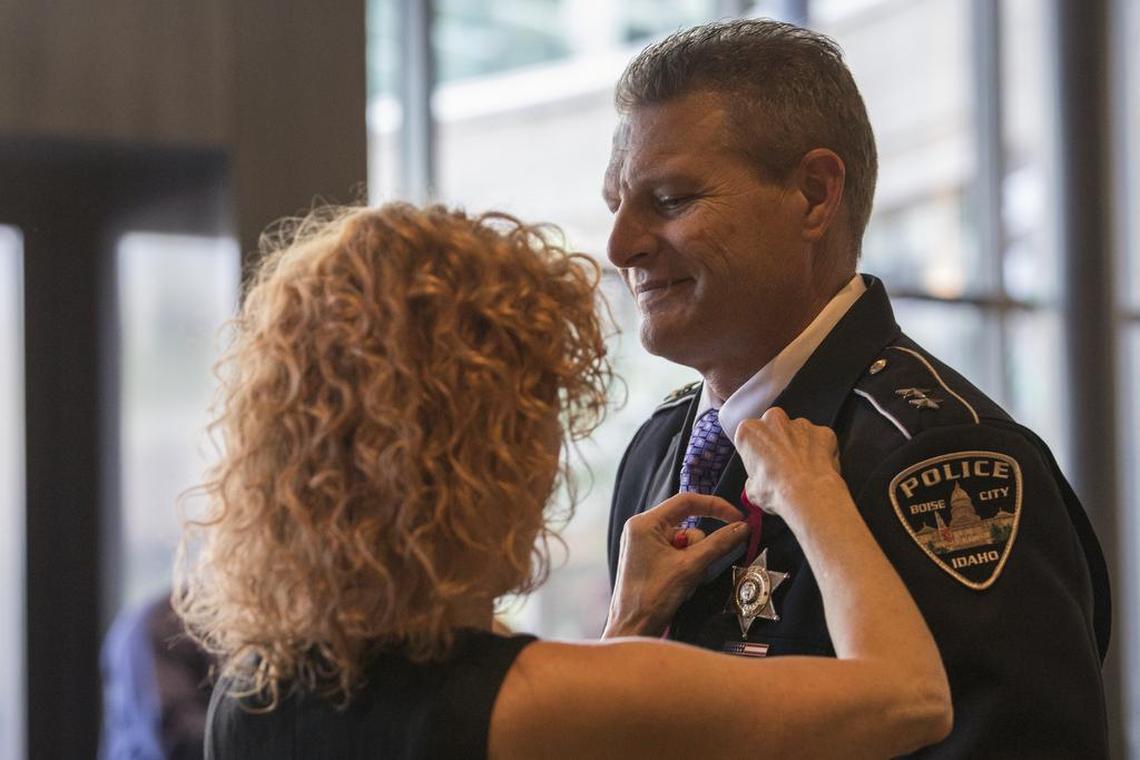 Jennifer Bones puts on a pink pin on Boise Police Chief Bill Bones before a memorial service for Ruya Kadir, a 3-year-old immigrant killed in a mass stabbing, at the Boise Centre in July 2018.