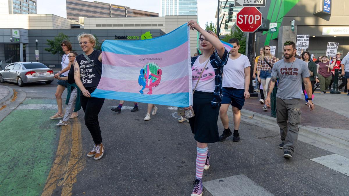 Demonstrators carry signs and flags to support transgender people during the Trans March in Boise in September 2024. LGBTQ+ leaders said this year’s slew of bills further dehumanize trans Idahoans and expose them to hate crimes.
