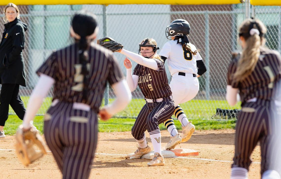 Vallivue's Bailee Hancock outs Bishop Kelly's Ysabella Villegas at first base during a game in 2022.
