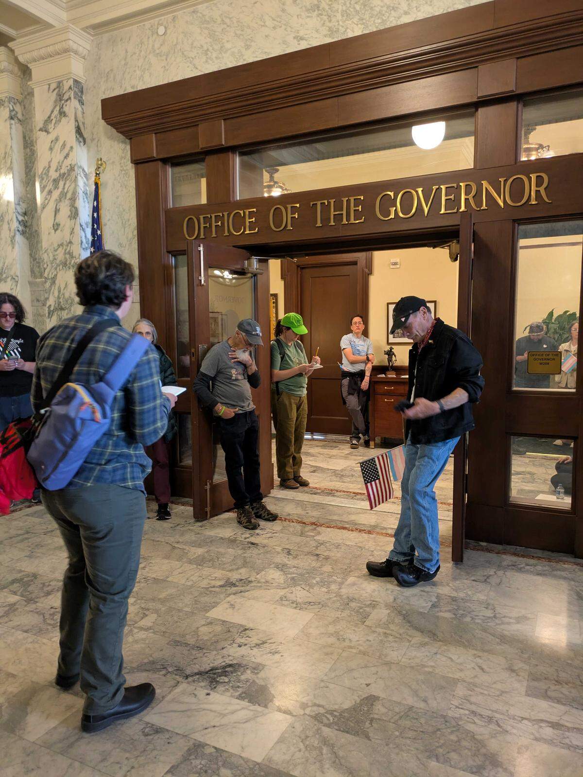 Protesters staged a sit-in demonstration at the office of Gov. Brad Little on Wednesday in the Idaho Capitol. Little’ recently signed a bill passed by the Legislature that criminalizes people using public bathrooms that don’t match their sex assigned at birth.