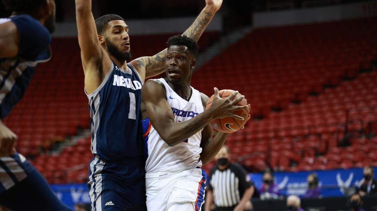 Emmanuel Akot, right, and the Boise State men’s basketball team were eliminated from the Mountain West Tournament after an 89-82 loss to Nevada. The Broncos were selected for the NIT.
