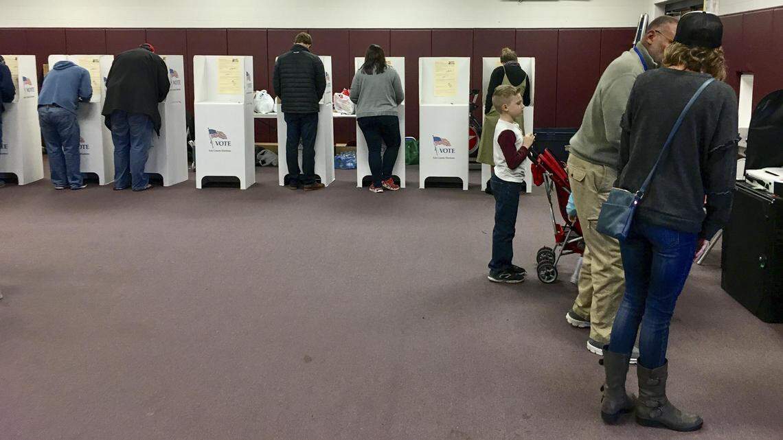 Voters wait Tuesday for a voting booth to open up at the District 19 precinct at Riverglen Junior High School in Northwest Boise. A polarized national political climate and the citizen-proposed Medicaid-expansion measure on Idaho’s ballot likely contributed to extraordinary voter turnout, a Boise political scientist says.