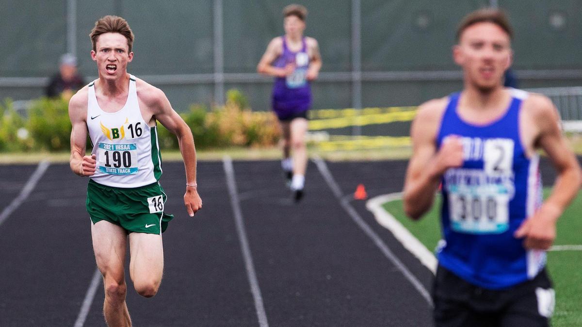 Borah’s Nathan Green, left, prepares to lap an opponent in the 3,200 meters at the 5A state track meet in May. Green won his fifth Gatorade athlete of the year award last week.