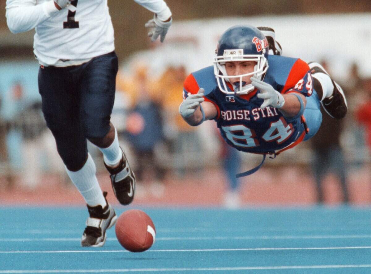 Boise State wide receiver Lou Fanucchi dives for a pass on the blue turf of Bronco Stadium in a conference game against Utah State, Saturday, Sept. 28, 2002.
