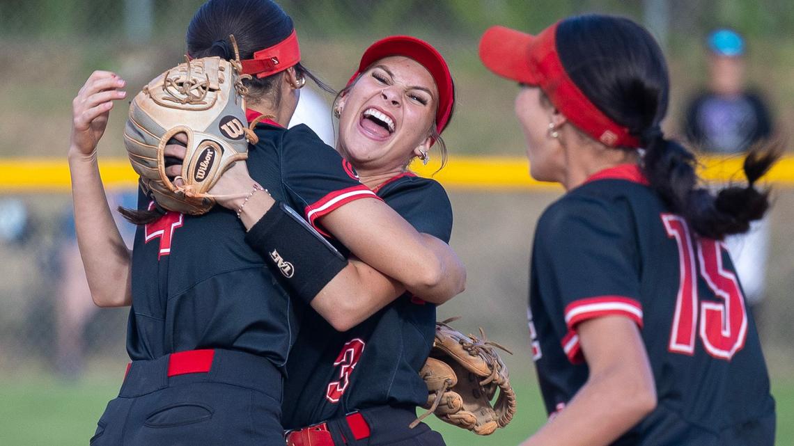 Owyhee seniors Kina Watts, left, Emma Bravo, center, and Molly Buckingham, right, celebrate their win over Rocky Mountain in the 5A District Three Tournament championship Thursday at Mountain Cove Field.