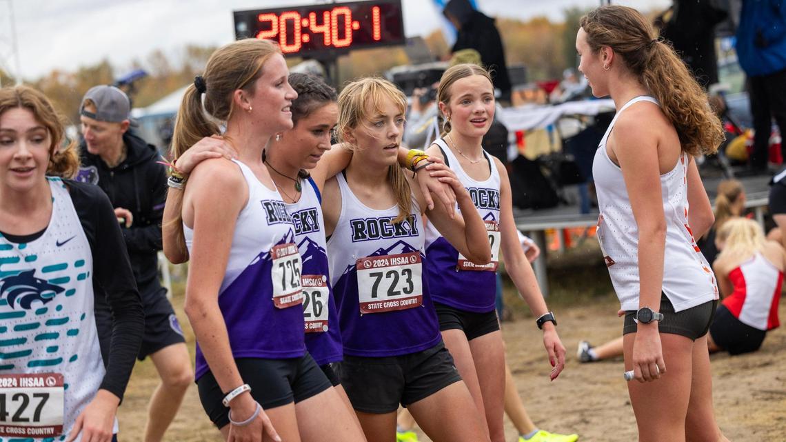 Girls from Rocky Mountain pose for a photo at the finish line after winning their first team state championship Saturday at the state cross country meet at Eagle Island State Park.