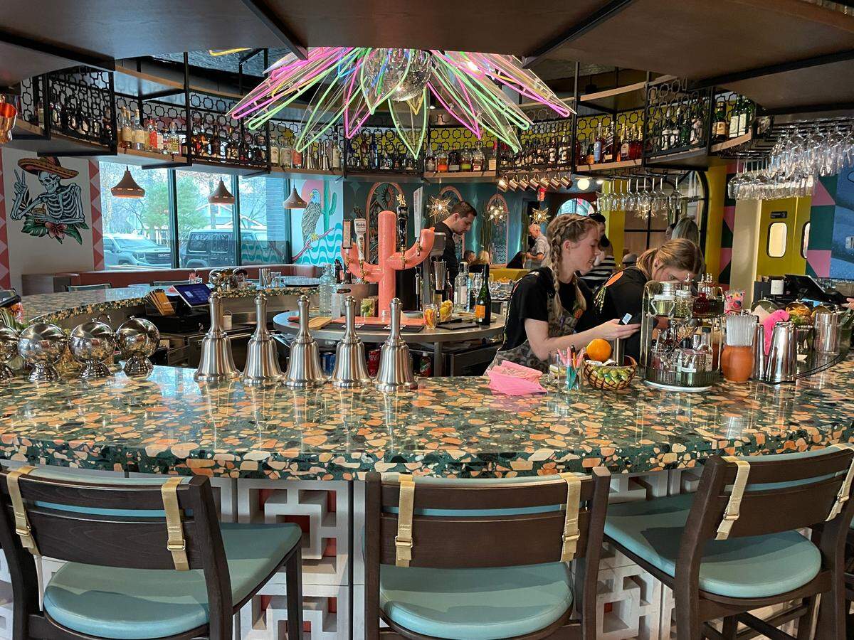 Draft beers are poured from taps on a pink cactus.