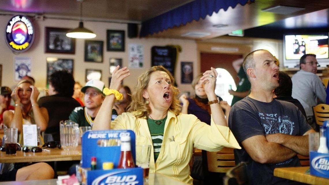 Pam Doucette, center, reacts to a Packers turnover Sunday afternoon at Hyde Park Pub & Grill, where Cheeseheads gather.