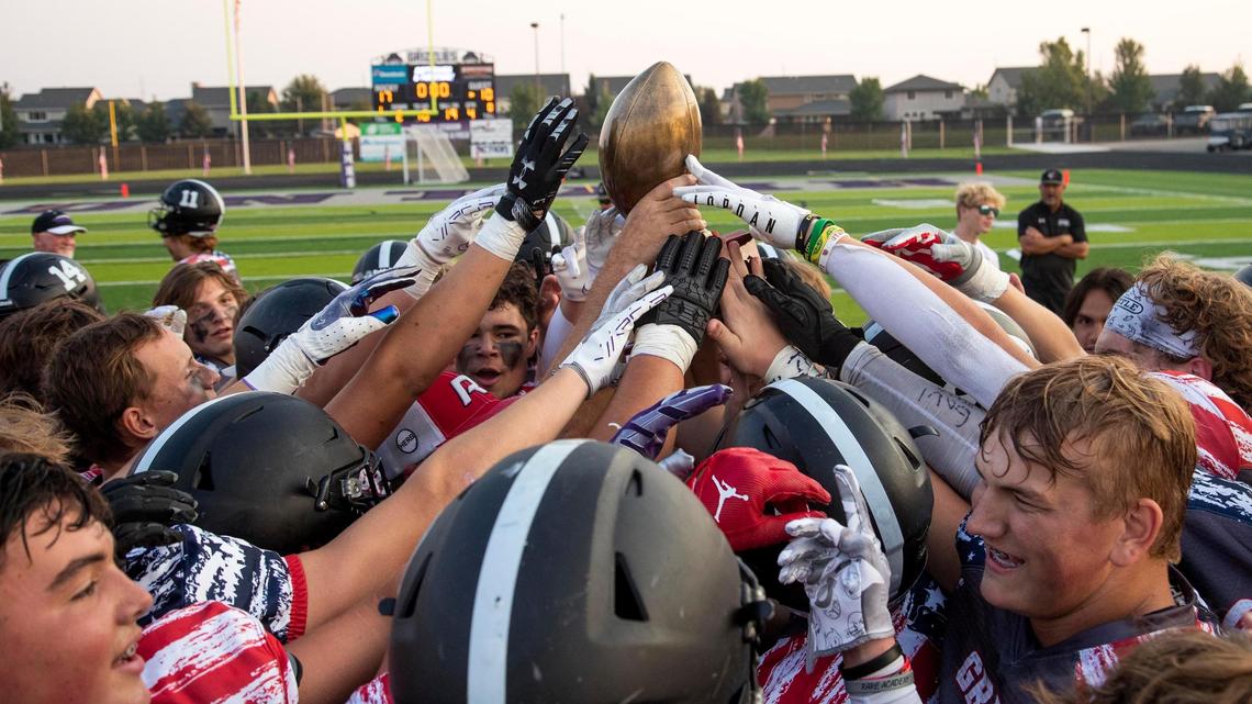 Rocky Mountain celebrates a 17-10 victory over Eagle with the Herb Criner Bowl rivalry trophy Saturday at Rocky Mountain High School in Meridian.