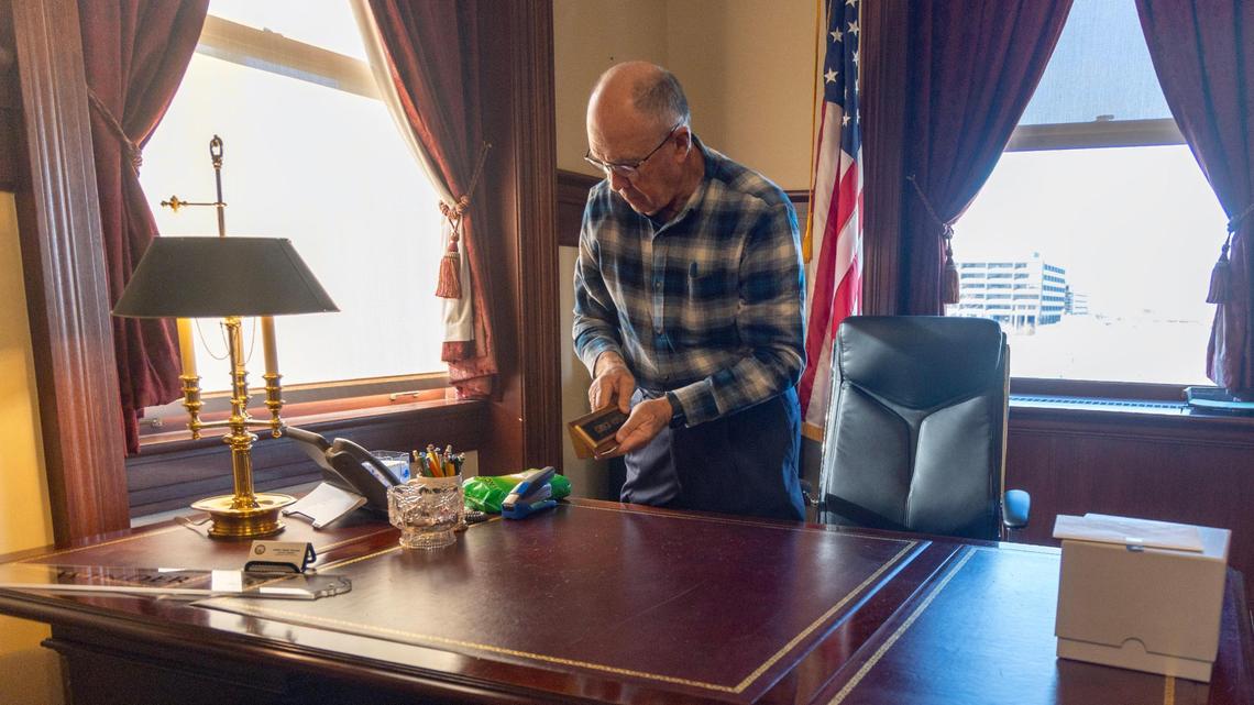 Sen. Chuck Winder packs away his personal items at his office.
