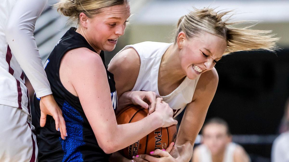 Timberline senior Piper Davis tries to pull the ball away from Rigby’s Mylee Graham on Thursday the Idaho Center.