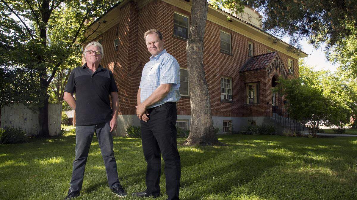 Ron McDonough, right, and George Cooper, left, are two of the partners buying the block where the Booth Home is located in Boise's North End. They plan to convert the 97-year-old main building, the former Booth Marian Pritchett School Program for Pregnant and Parenting Teens, into two condominiums. The rest of the property will be subdivided into home plots with the goal of keeping as many trees as possible.