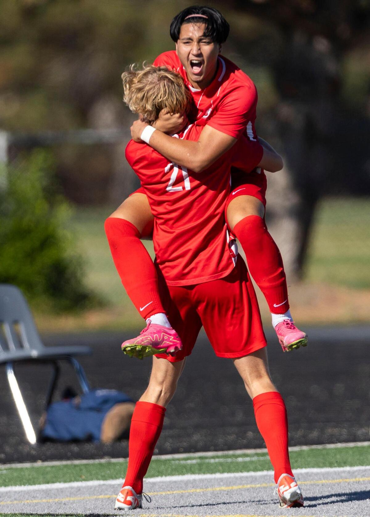 Boise senior Orion Werntz receives a jumping hug from teammate Sohail Ebrahimi after scoring the game-winning goal in the second overtime to defeat Centennial 2-1 in the first round of the the 5A boys soccer tournament Thursday at Eagle High.