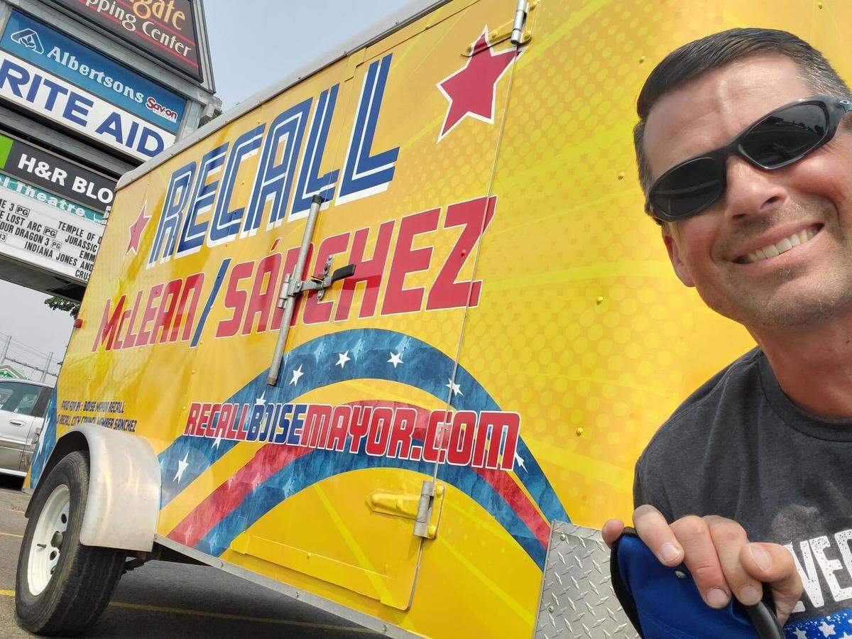 Joe Newton poses with the campaign’s wrapped trailer. Newton has been driving the trailer for the past three weeks.