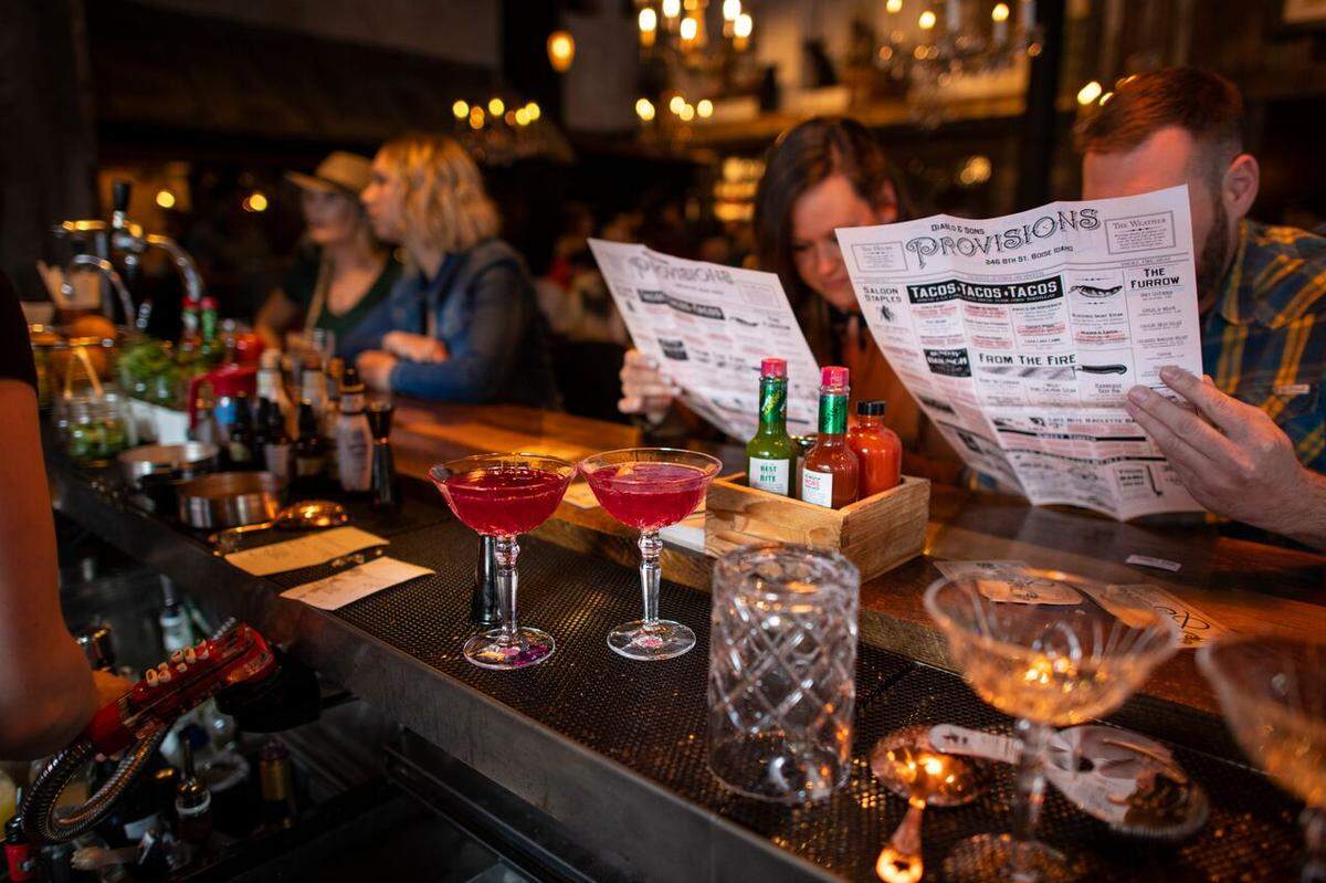 Customers check out the menu at a private event prior to Diablo & Sons opening to the general public.