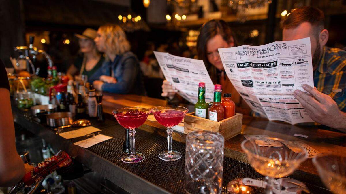 Customers check out the menu at a private event prior to Diablo & Sons opening to the general public.