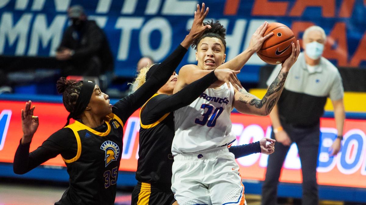 Boise State guard Jade Loville draws a foul driving by San Jose State defenders Cydni Lewis (35) and Courtesy Clark on Thursday, Dec. 31, 2020, at ExtraMile Arena in Boise. Loville made the shot and finished the play with a free throw, helping the Broncos in their 77-75 Mountain West victory.