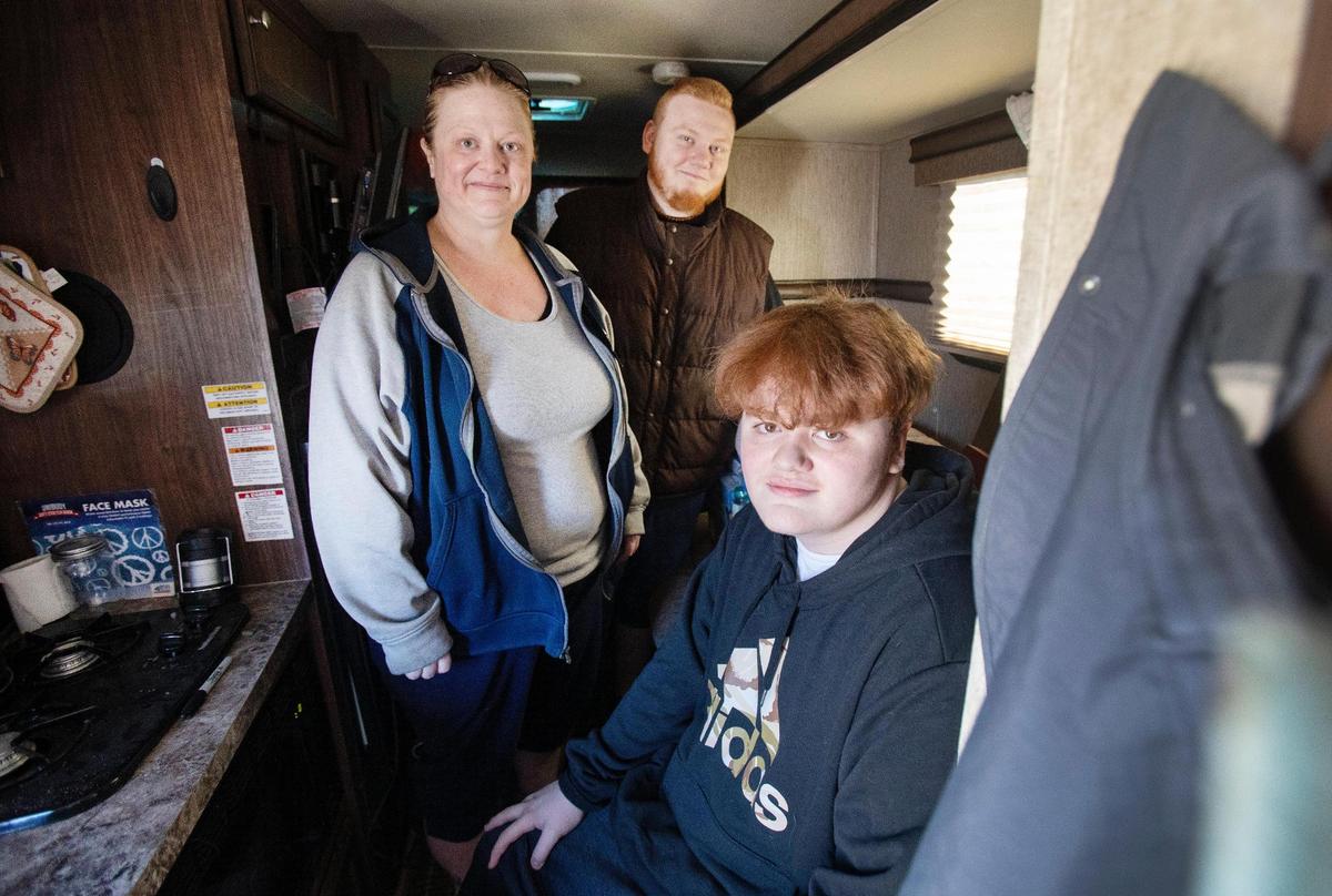 Teresa Thorne and her sons Tyler Thorne, 22, and Tayden Thorne, 15, stand inside a small trailer they are moving items into for the worst-case scenario that they will have to live in it after they lose their current home. The Thornes must move out of the house they’ve rented for eight years because the landlord has a family member who lost a home and needs somewhere to live. They are looking for a home that accepts their housing-choice voucher.
