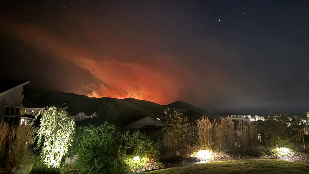 The Valley Fire burns near Harris North homes in the Boise Foothills before sunrise Friday.
