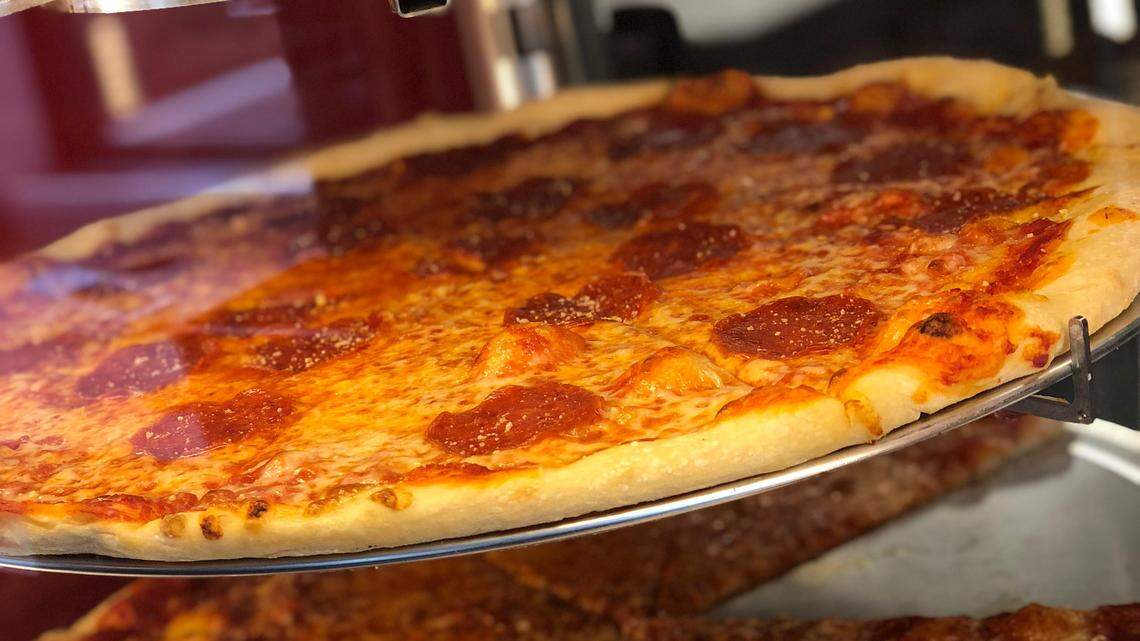 Pizza by the slice is hot and “lightning fast” at Johnny Bronx. If you want to buy a whole, 20-inch pizza, order in advance unless you want to wait 12 to 15 minutes.