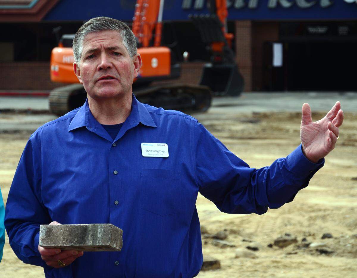 John Colgrove, president of Albertsons' Intermountain Division, holds a brick from the Boise chain's original store at 16th and State streets, which opened in 1939, to symbolize the company's deep roots in the community. He brought it Thursday to the site of the Broadway Avenue store, which opened 20 years later, as demolition began to make way for a larger replacement.