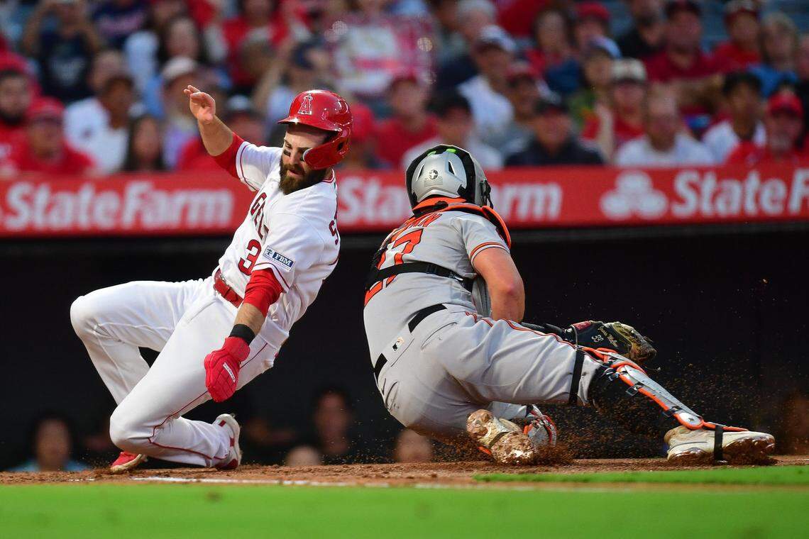 Sep 4, 2023; Anaheim, California, USA; Los Angeles Angels second baseman Michael Stefanic (38) scores a run past Baltimore Orioles catcher James McCann (27) during the second inning at Angel Stadium. Mandatory Credit: Gary A. Vasquez-USA TODAY Sports