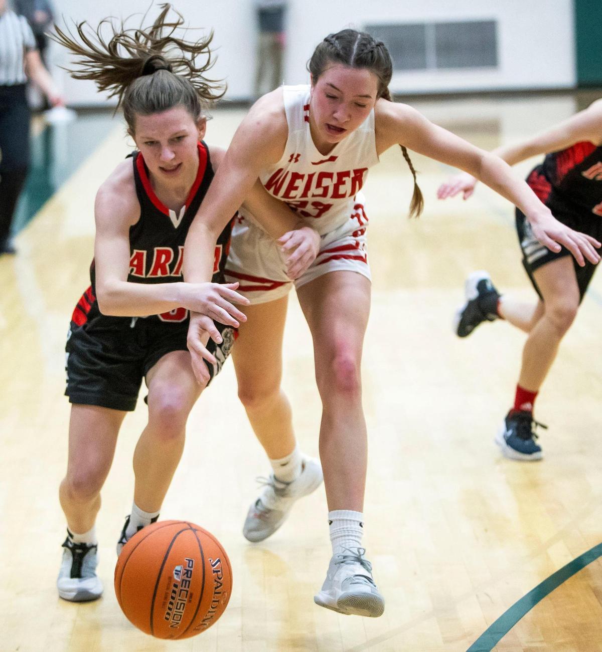 Weiser’s Mattie Shirts, right, and Parma’s Sidney Jackson chase a loose ball during last year’s 3A state tournament.