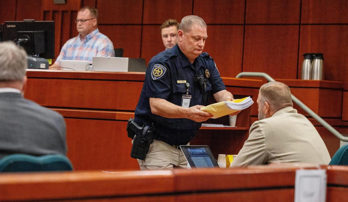 Ammon Bundy is presented with arraignment documents during his hearing Aug. 29, 2023, at the Ada County Courthouse in Boise.