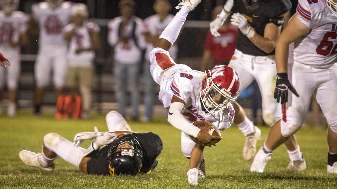 Nampa quarterback Donavon Estrada stretches for some extra yardage in the fourth quarter of Nampa’s 40-20 win at Bishop Kelly on Friday, Aug. 30, 2019.