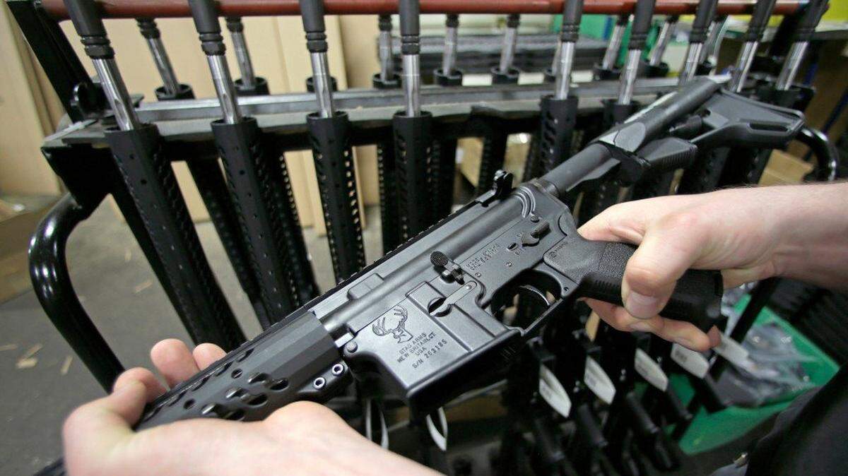 Craftsman Veetek Witkowski holds a newly assembled AR-15 rifle at the Stag Arms company in New Britain, Conn. The City Council in Republic, Washington, is mulling legislation to shield itself from gun restrictions that state voters passed under Initiative 1639.
