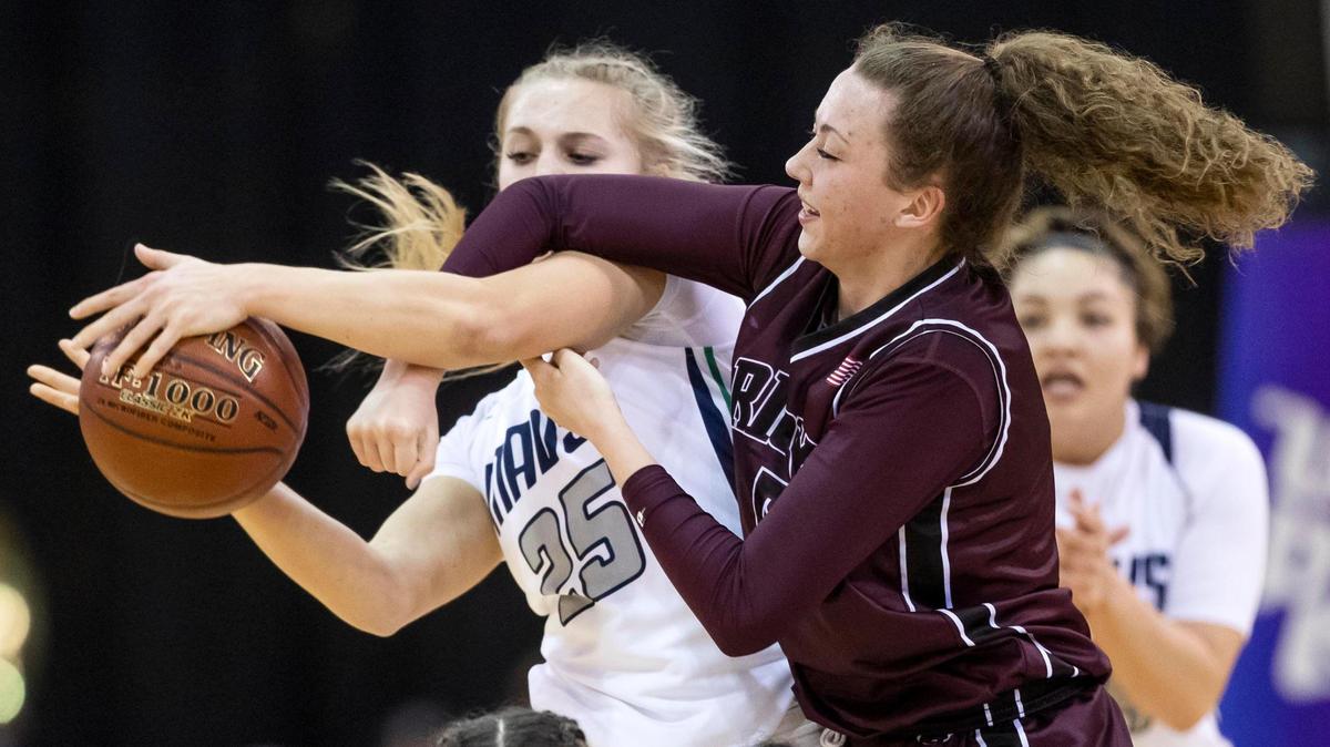 Mountain View senior Millie Brunner protects the ball from Rigby’s Tylie Jones during the semifinals of the 5A girls basketball state semifinals Friday at the Ford Idaho Center in Nampa.