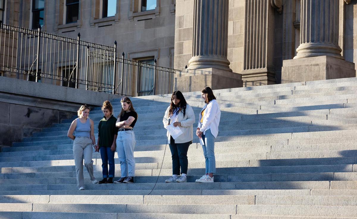 Student leaders of the organization March for Our Lives Idaho close their eyes in a moment of silence after reading the names of the children and teachers killed in a school shooting in Uvalde, Texas one week ago.