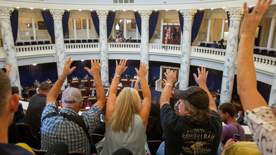 Spectators in the Idaho House gallery on Aug. 25 silently indicate their approval for speakers who supported a resolution that would end the coronavirus emergency declaration that Gov. Brad Little signed in March. The resolution passed 48-20.