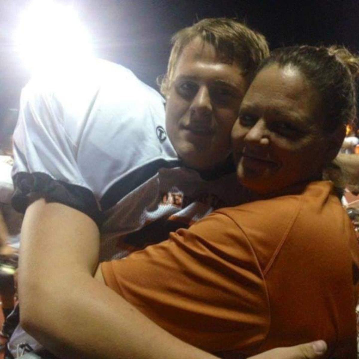 Justin Friesner embraces his mother, Summer Friesner.