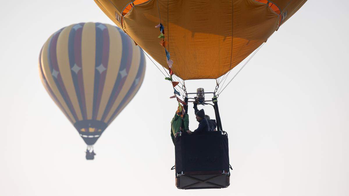Hot air balloons fly Friday in smoky skies for the Spirit of Boise event.