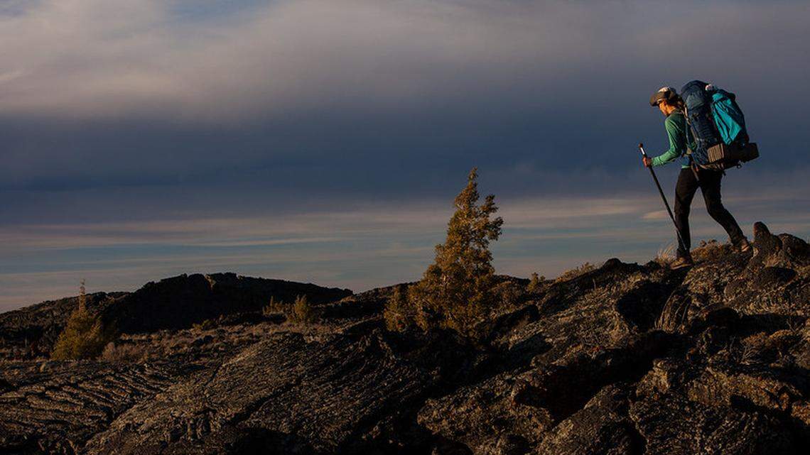 A hiker is shown in Craters of the Moon.
