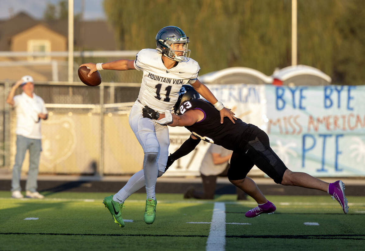 Mountain View senior quarterback Henry Nelson tries to avoid a sack from Rocky Mountain senior linebacker Owen Weatherly earlier this season. Mountain View hosts Highland, and Rocky Mountain hosts Owyhee in the first round of the 6A football playoffs Friday.